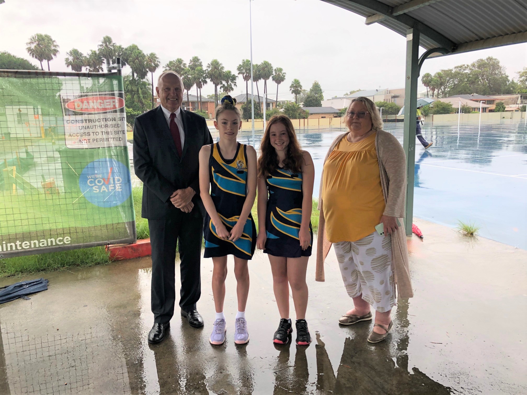 Council Administrator Rik Hart is joined by local Ettalong Eagles Netball Club players (Taylah Sankey and Sophie Planicka), and Woy Woy Peninsula Netball Association President, Sharon Bailey at Lemon Grove Netball Courts, Ettalong. Works are underway in 