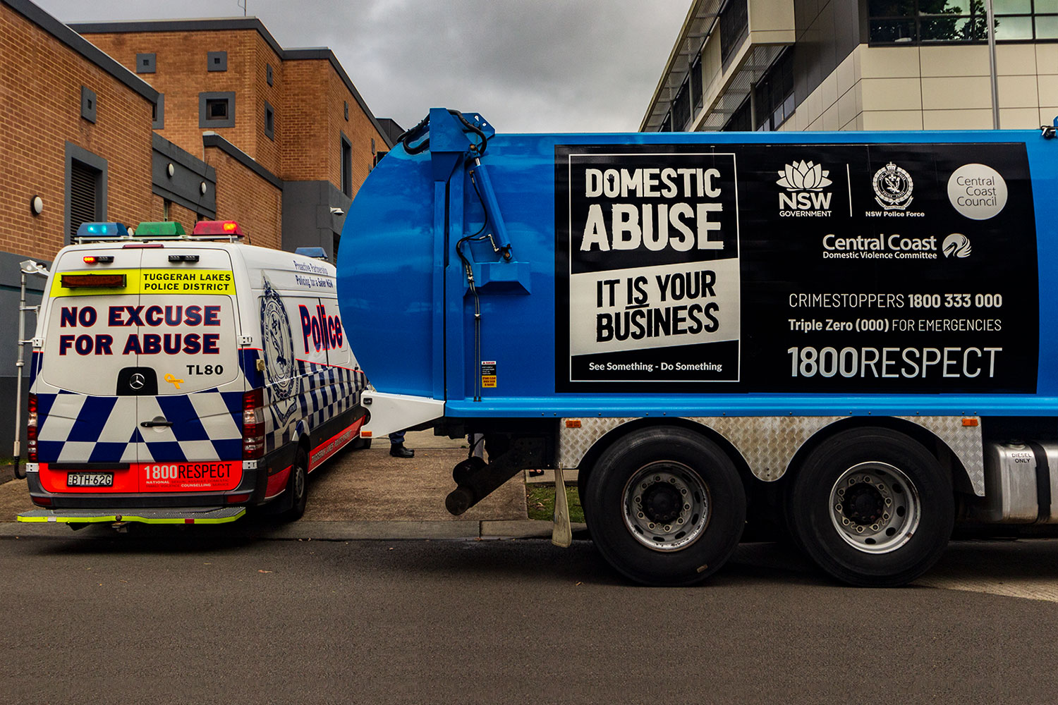 truck and police car with anti DV messaging 