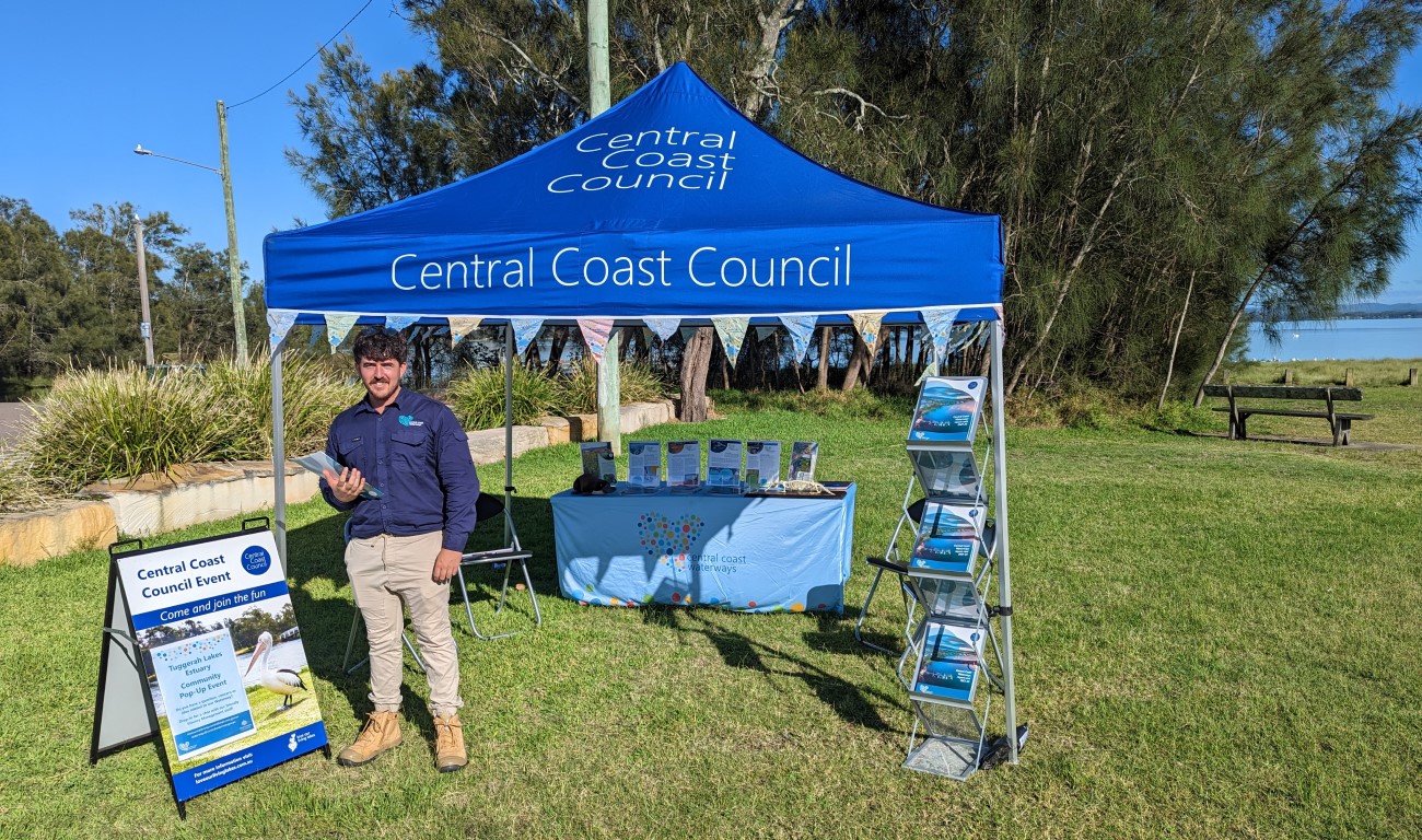 Council branded gazebo on the foreshore with staff member