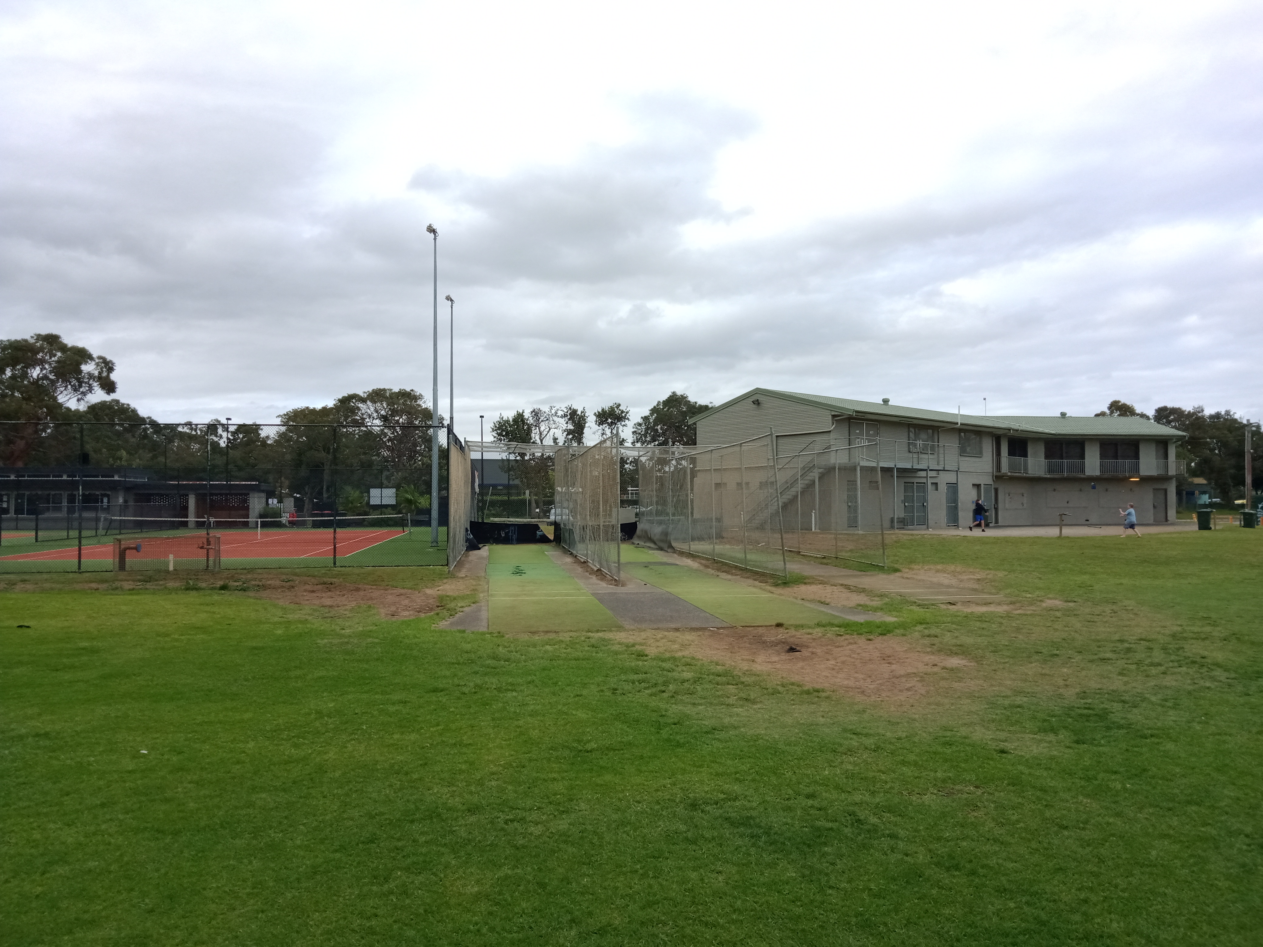 Sports oval with cricket nets, Tennis courts, sports amenities in background at Umina 