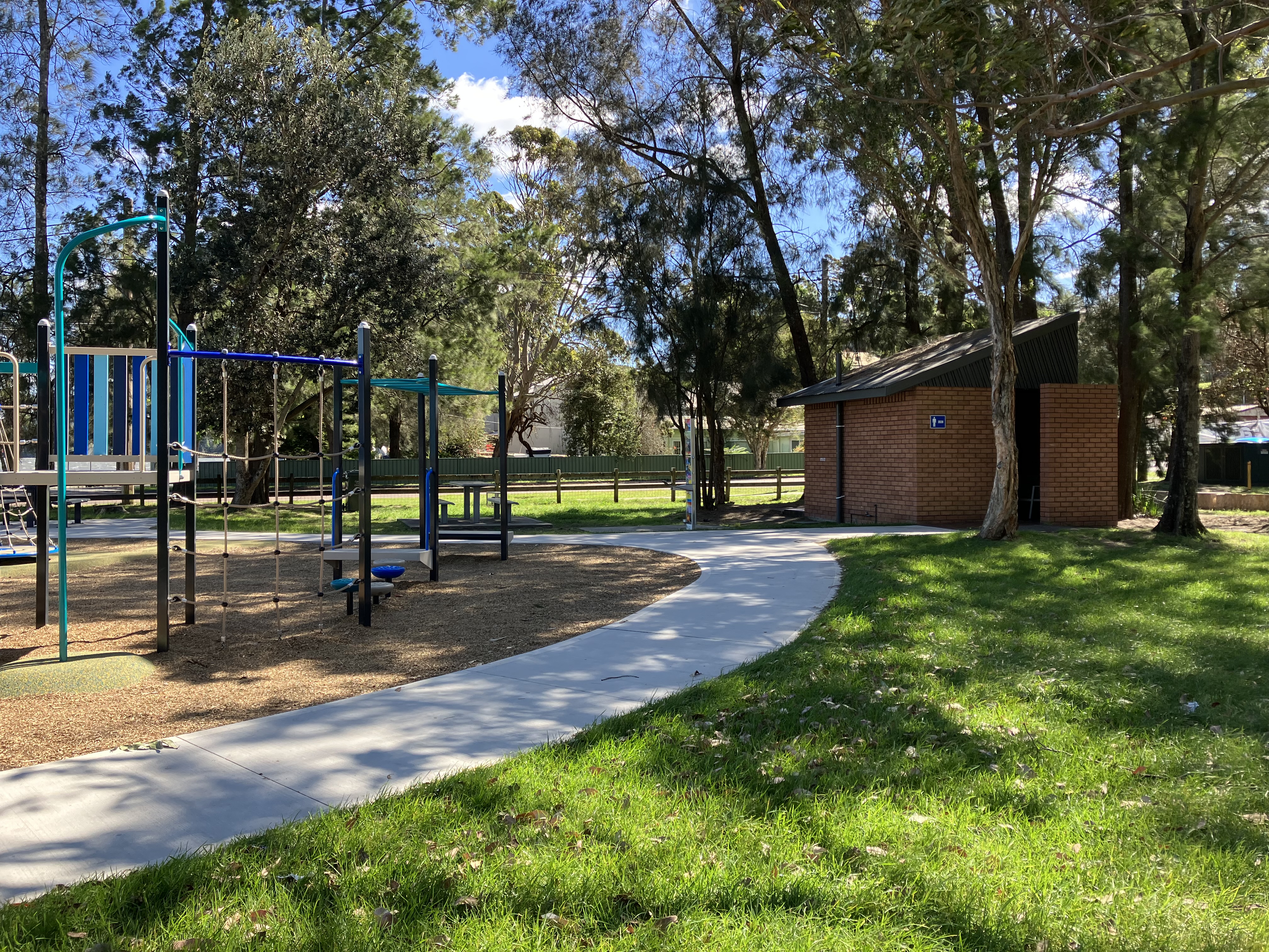 pathway with public toilets and grass and playground