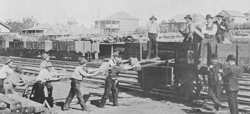 Black and White historical image - Railway workers loading sleepers onto railway car Wyong c1909